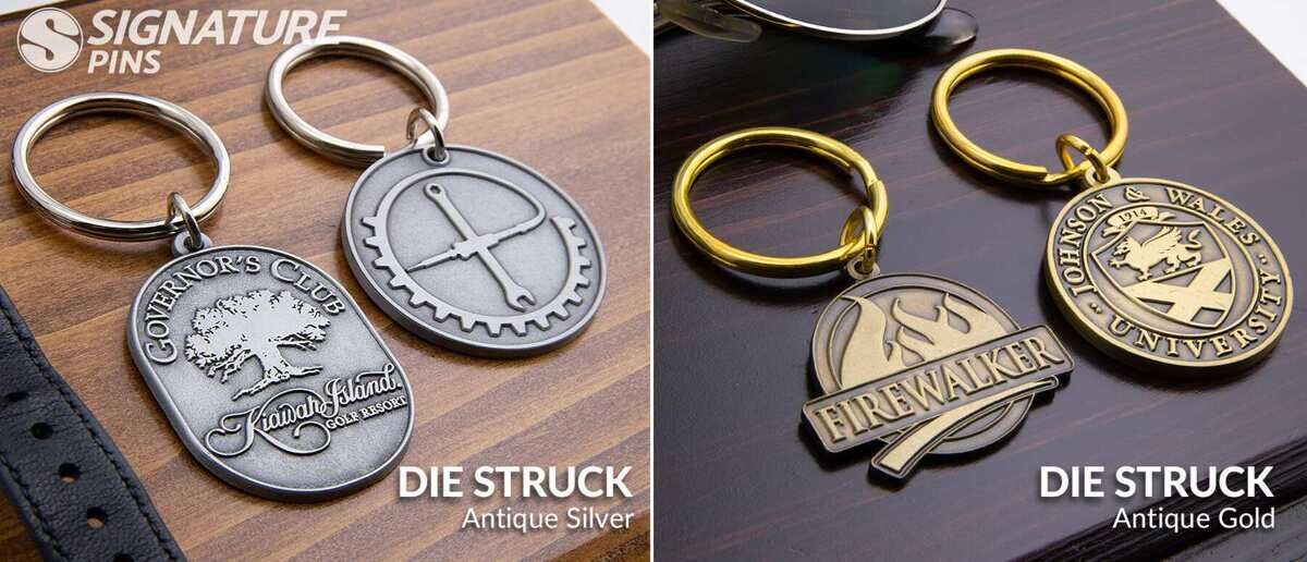 Die struck keychains in antique silver and antique gold including golf club and university seal designs