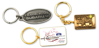 Single sided custom keychains showing Subaru dealership, offset printed, and antique metal designs