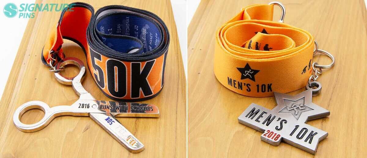 Custom shaped race medals including scissors-shaped 50K medal and star-shaped Mens 10K medal with printed lanyards
