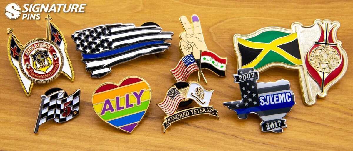Custom flag pins including thin blue line American flag, LGBTQ ally heart, Jamaica flag, checkered racing flag, and Honored Veteran pins