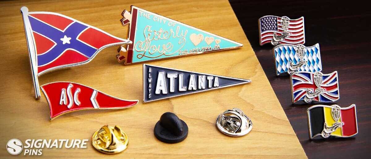 Pennant-style sports pins and world flag pins featuring US, UK, Bavaria, and Belgium flags