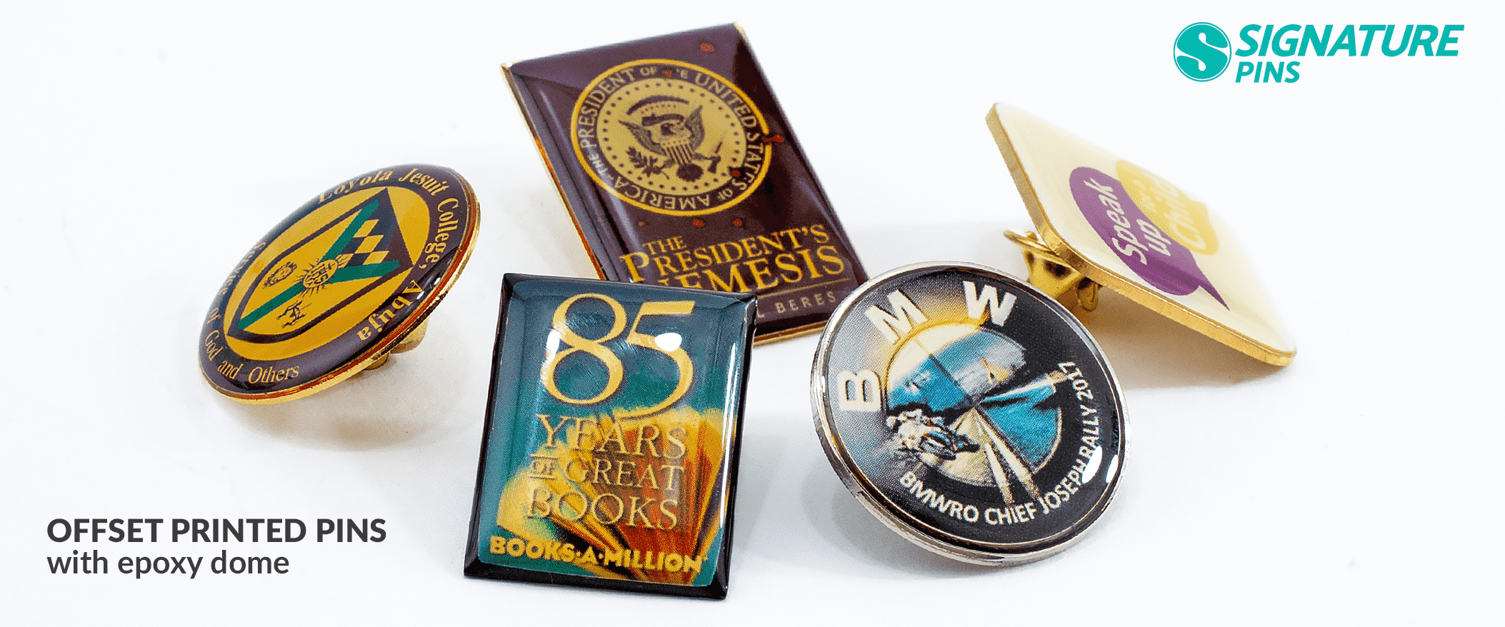 Assortment of offset printed pins with epoxy dome including presidential seal pin, 85 Years of Great Books pin, and BMW aerospace pin