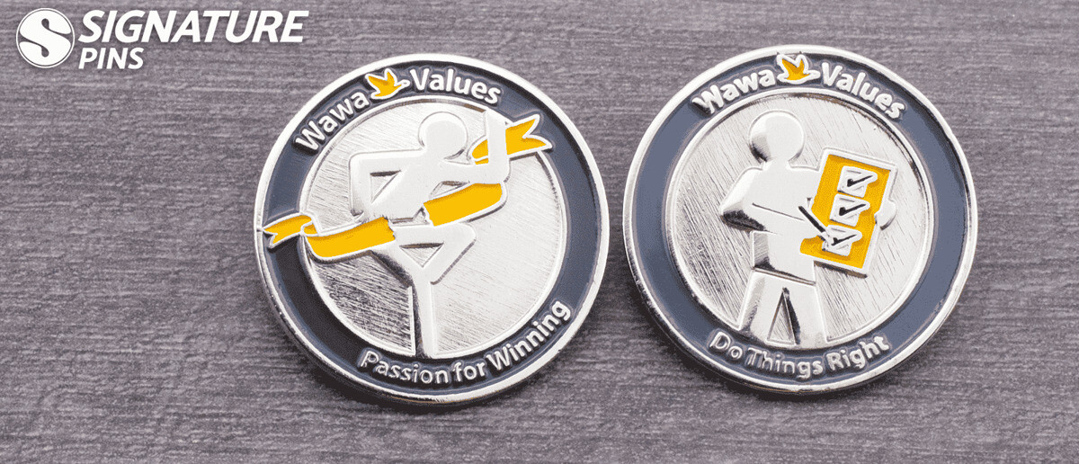 Two Wawa Values corporate pins in silver and black featuring Passion for Winning and Do Things Right slogans with figure icons