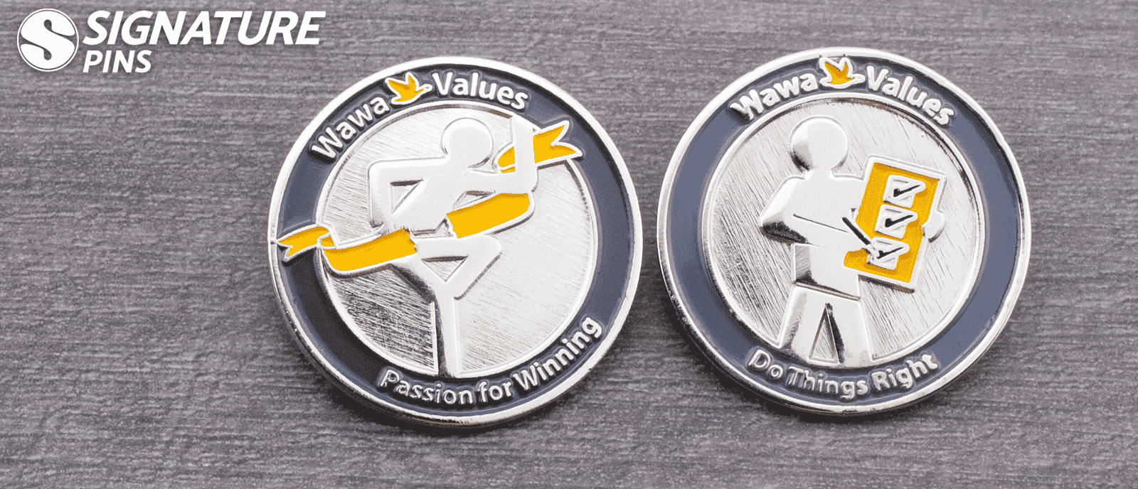 Two Wawa Values corporate pins in silver and black featuring Passion for Winning and Do Things Right slogans with figure icons