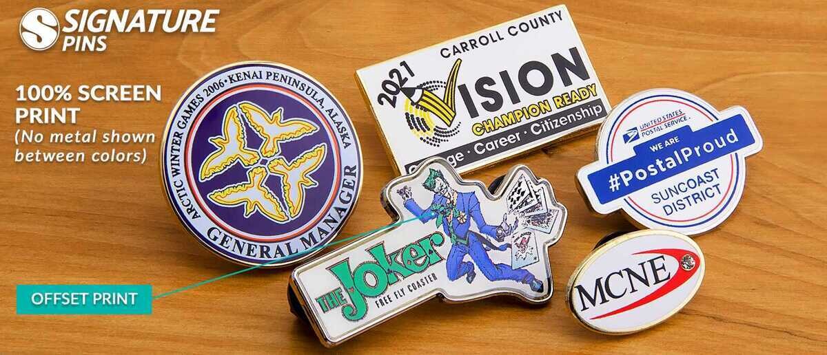 Full silkscreen pins showing 100% coverage designs including Arctic Winter Games, Joker coaster, and Postal Proud